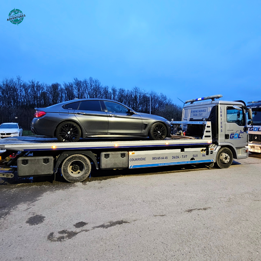 Car being recovered on a tow truck in Belgium after a breakdown