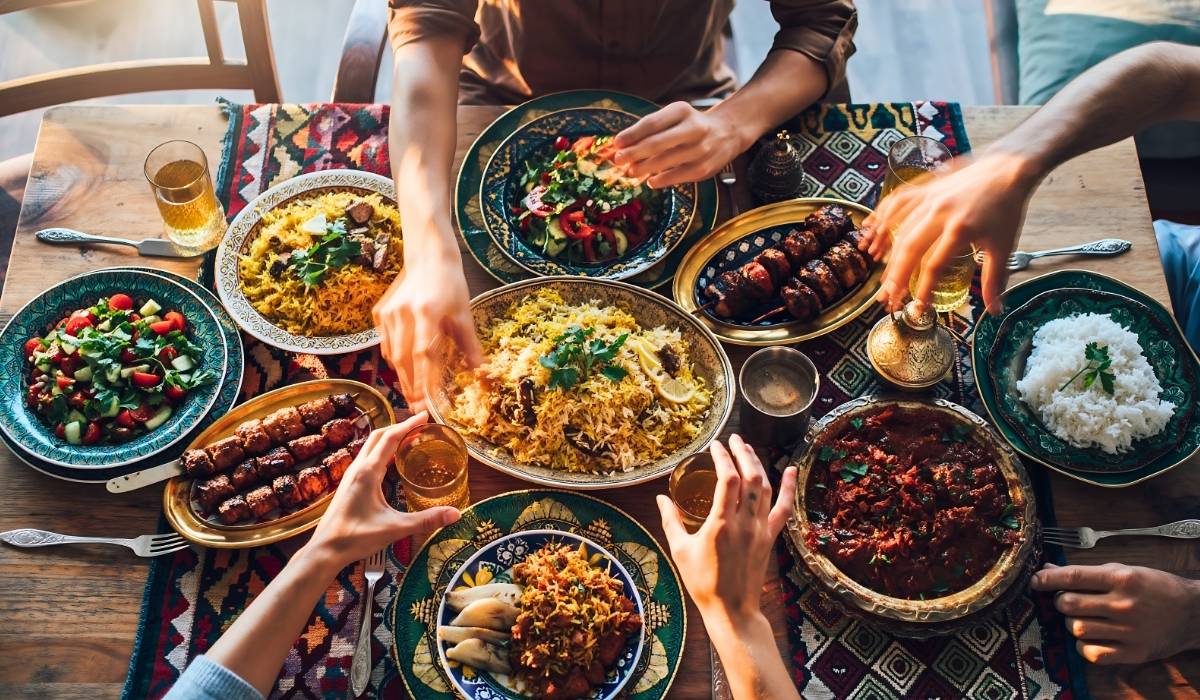 Shared meal with multiple dishes on a wooden table