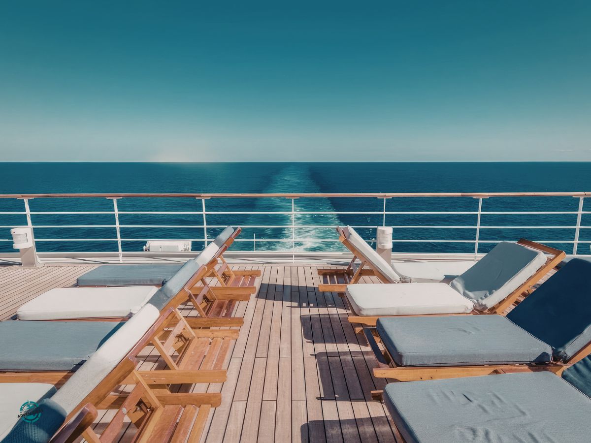 Relaxed cruise ship deck with sun loungers overlooking a calm sea, a popular choice for multigenerational holidays planned by World Class Adventures