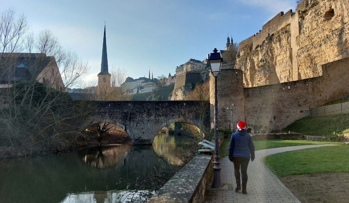 Riverside walk in Luxembourg with bridge and historic walls