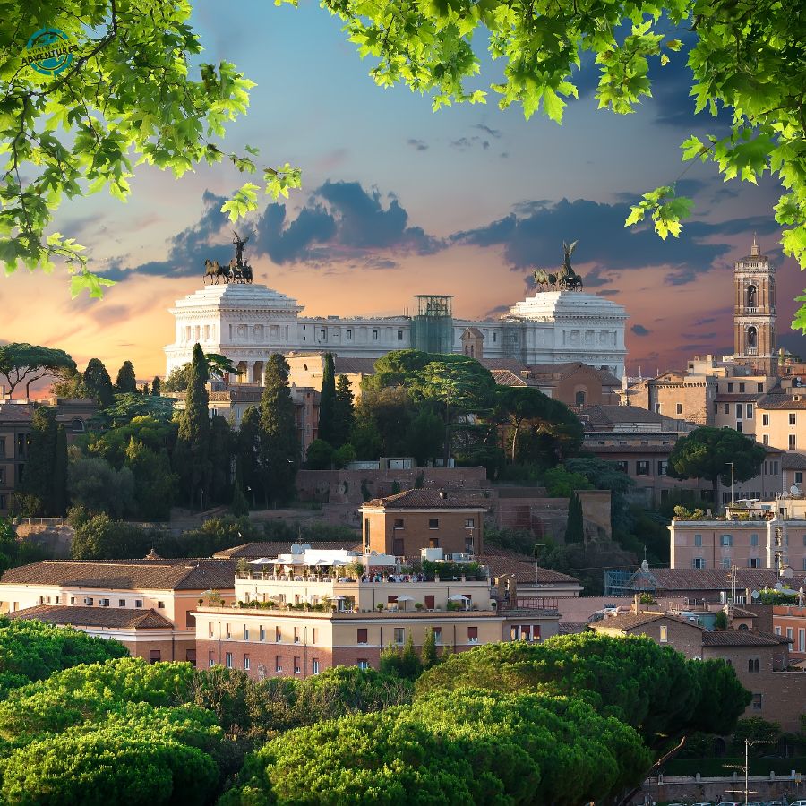 View across Rome at dusk with the Vittoriano monument rising above the rooftops and trees